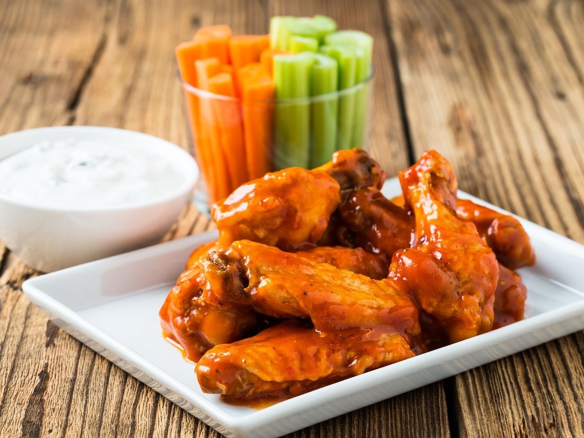 A plate of sauced chicken wings