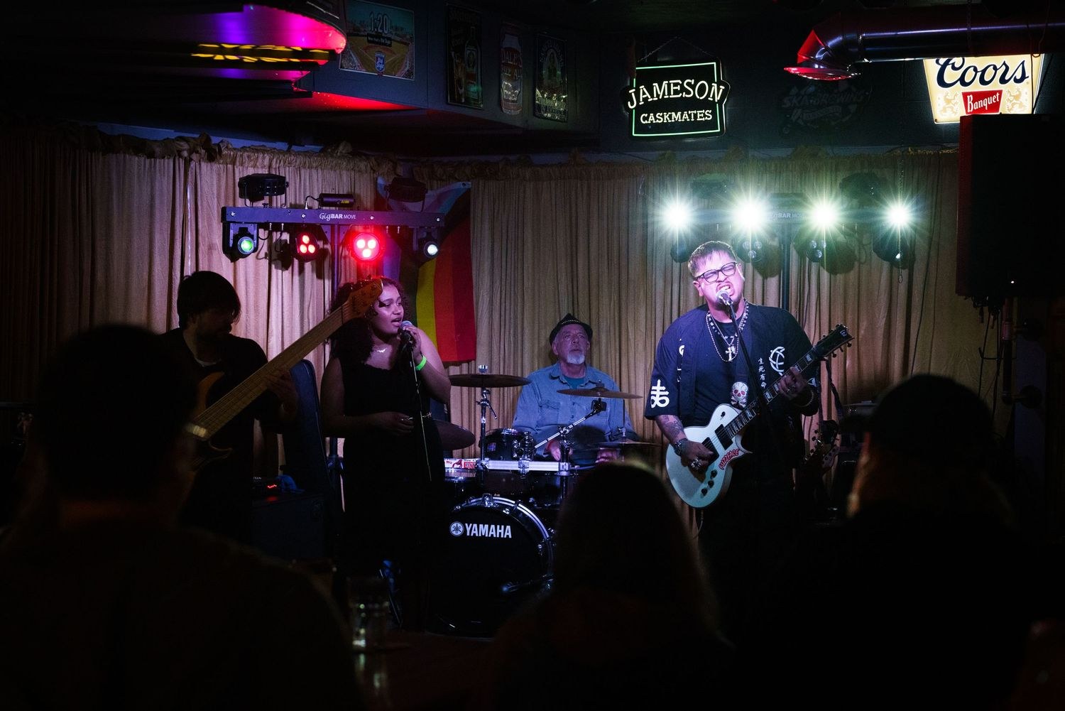 A live band performing on a bar stage