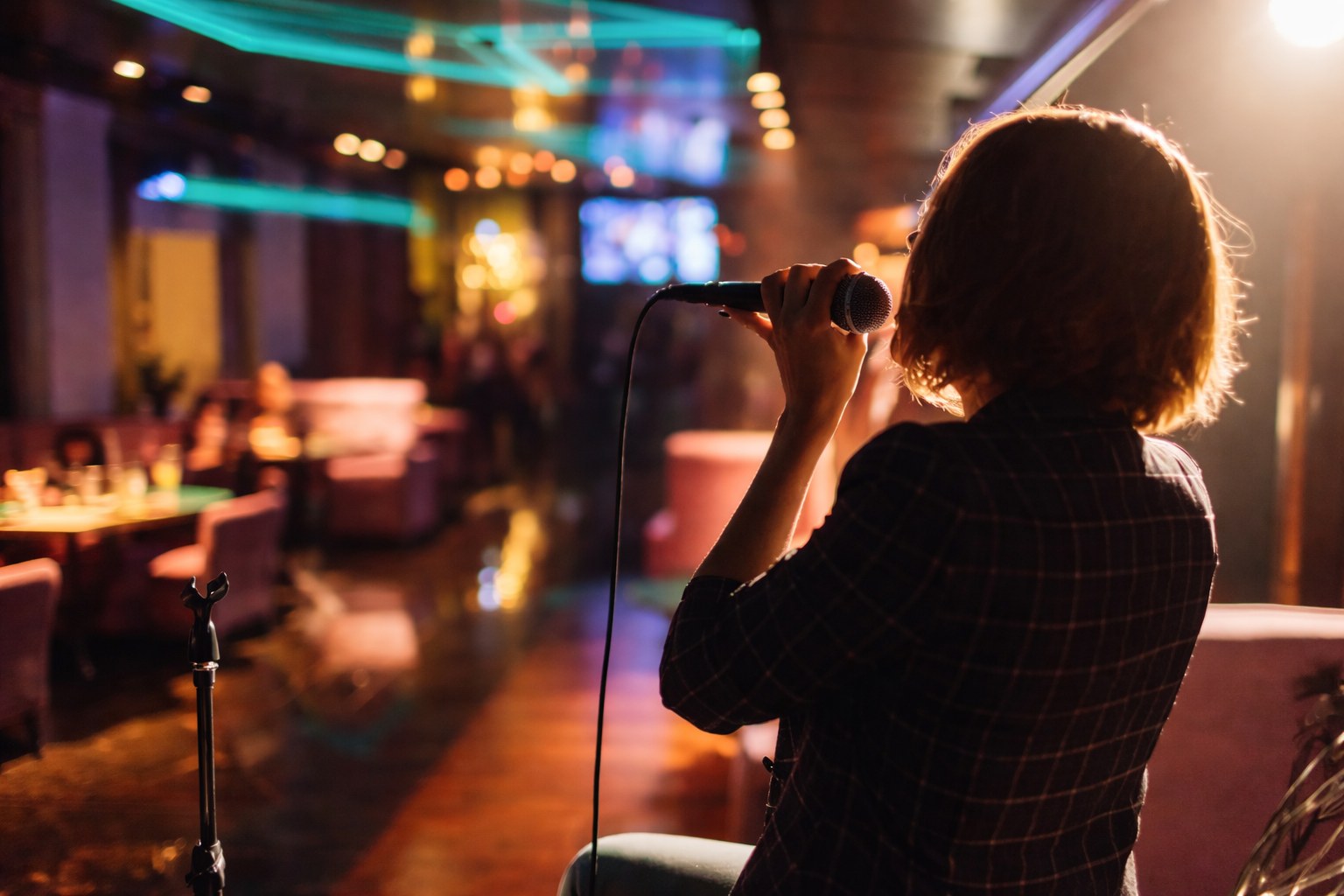 A singer with a microphone on karaoke night