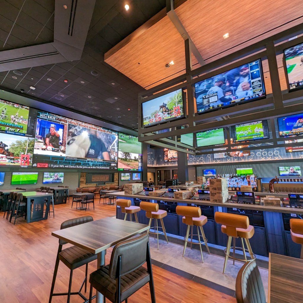 A wall of television screens showing different games